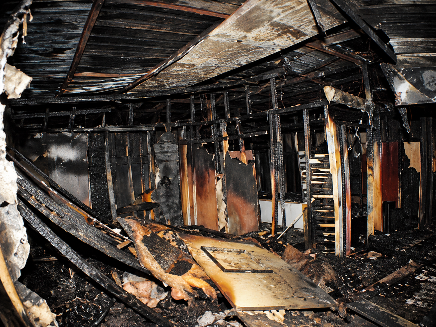 Interior fire damage at the Haunted Hotel showing charred framing and damaged building materials after the 2014 electrical fire.