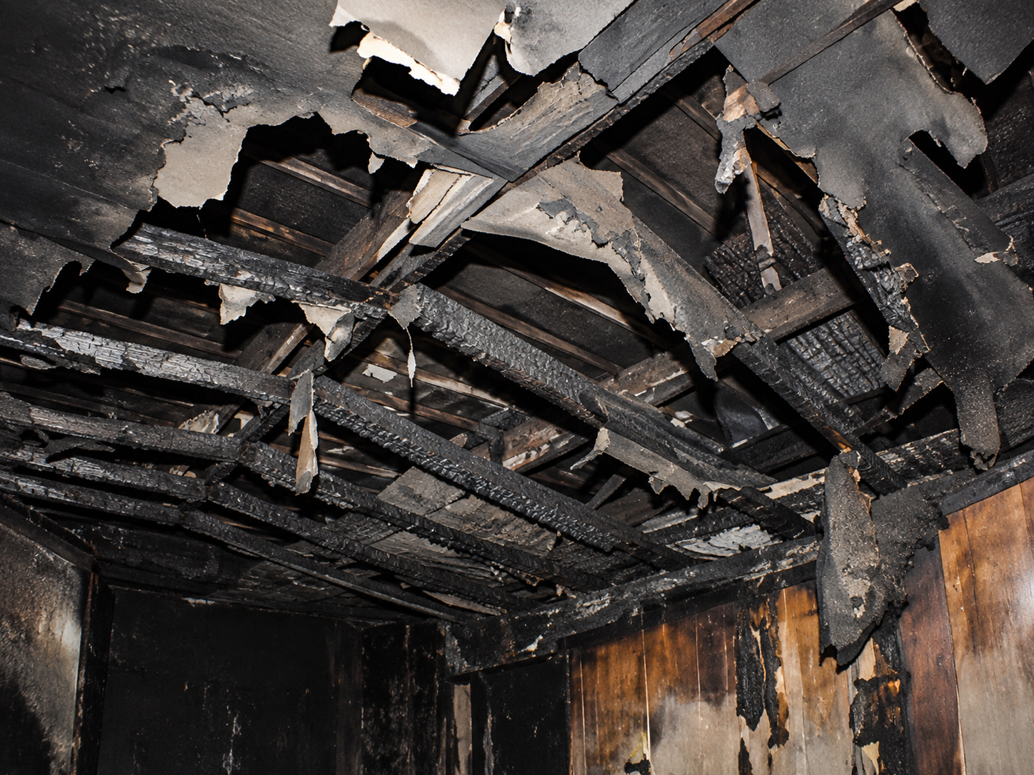 Fire-damaged ceiling and structural framing inside the Haunted Hotel after the 2014 electrical fire.
